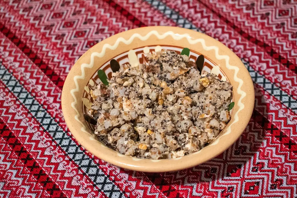 A bowl of kutia — wheat berries with poppy seeds, honey and walnuts — on an embroidered red Ukrainian cloth