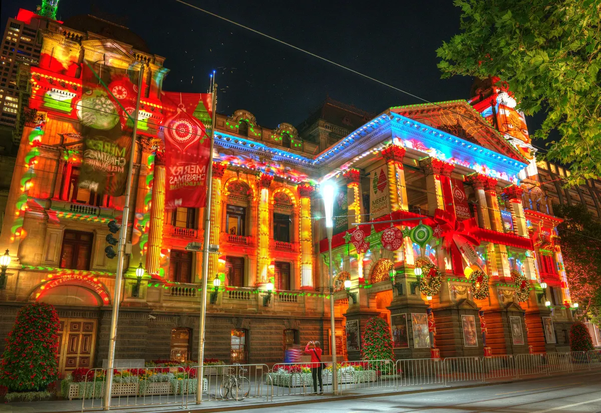 Melbourne Town Hall facade covered in colourful Christmas light projections at night
