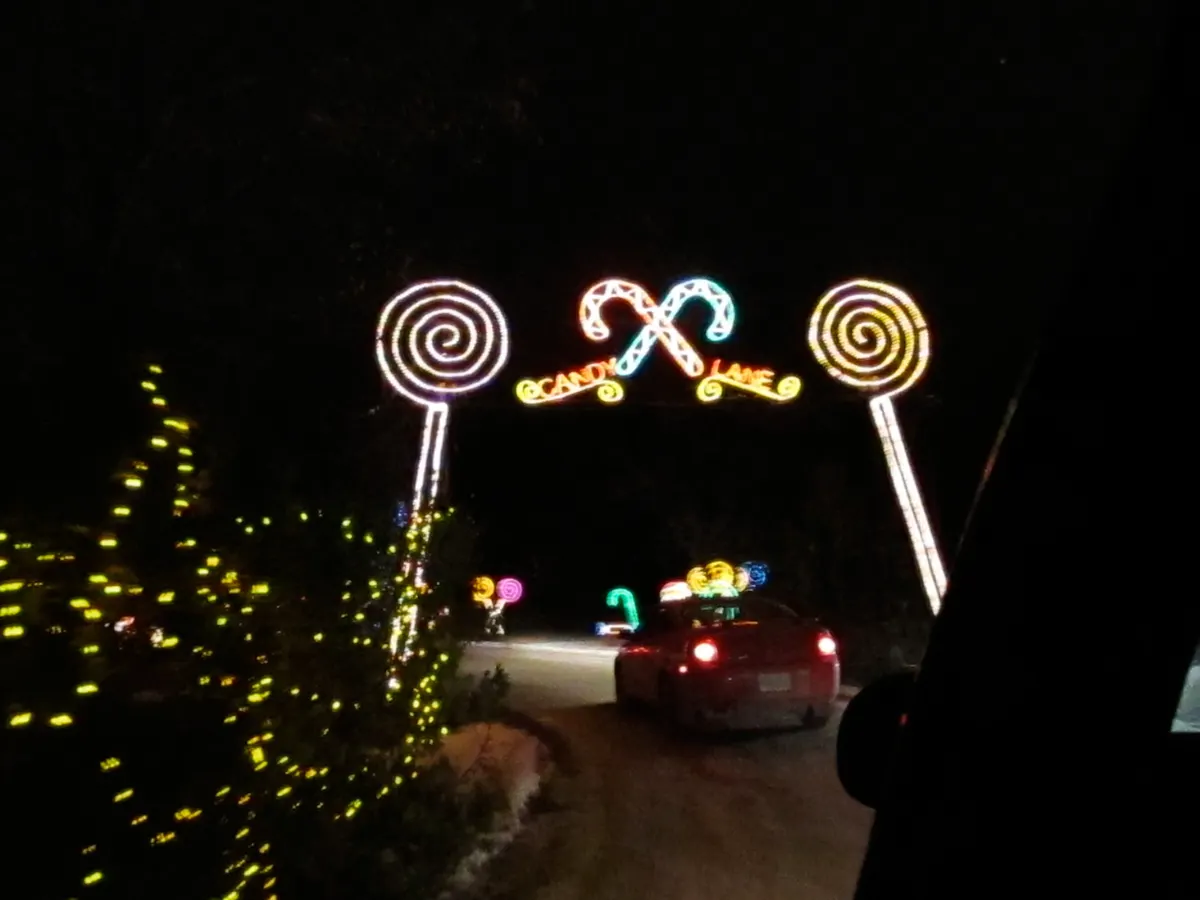 Candy Lane archway of lollipops and candy canes lit up at the Enchanted Forest drive-through
