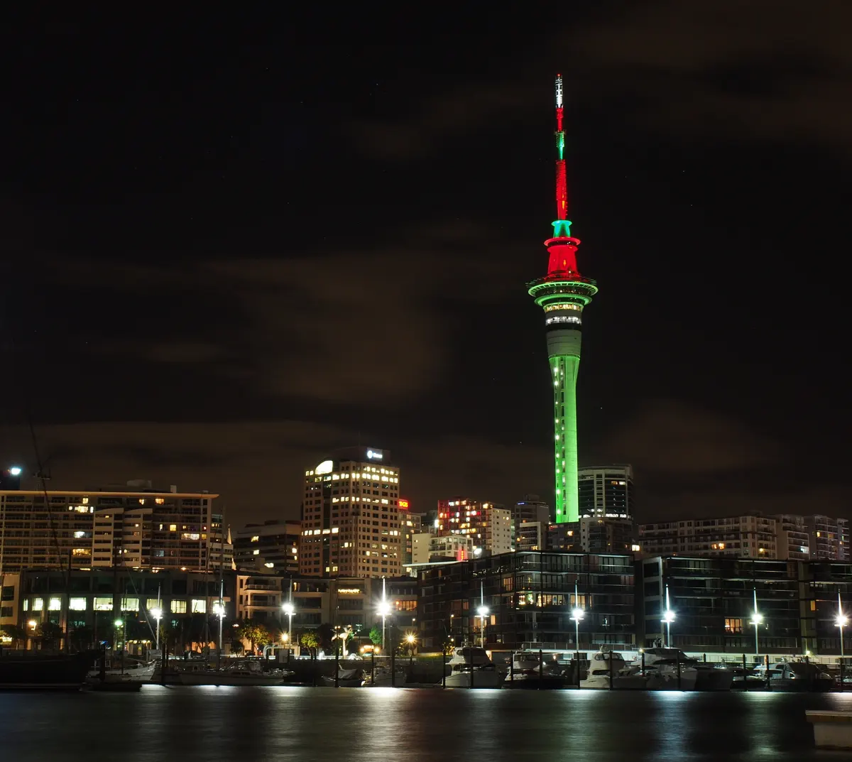 Auckland Sky Tower lit in red and green Christmas colours at night