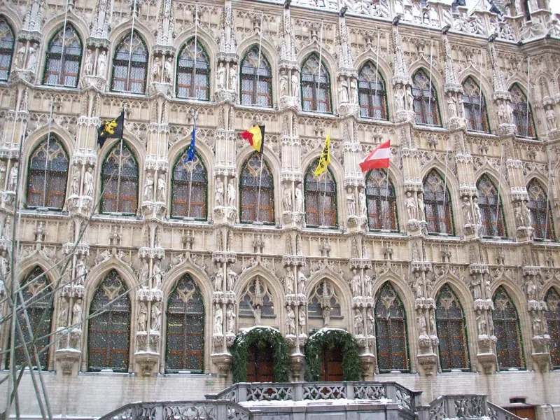 Gevel van het Leuvense stadhuis met kerstkransen aan de ramen
