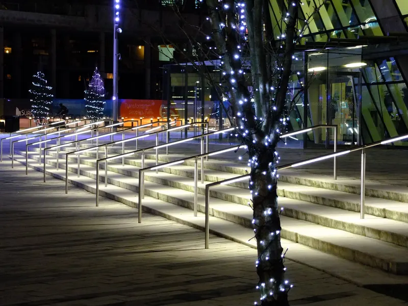 Steps and trees with Christmas lights at Surrey City Hall plaza and library
