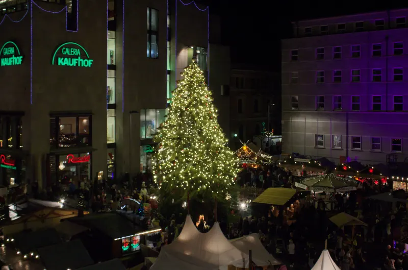 Beleuchteter Weihnachtsbaum und Zeltdächer auf dem Marktplatz in Halle