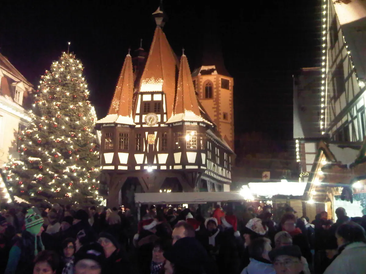 Michelstädter Rathaus mit großem Weihnachtsbaum und Menschenmenge am Abend