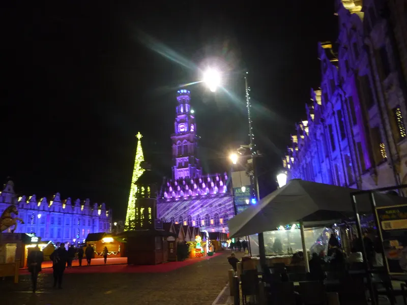 Beffroi d'Arras illuminé en violet pendant la Cité de Noël