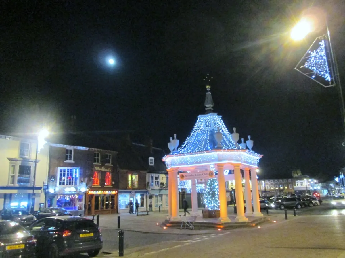 Beverley Market Cross lit with blue Christmas lights at night