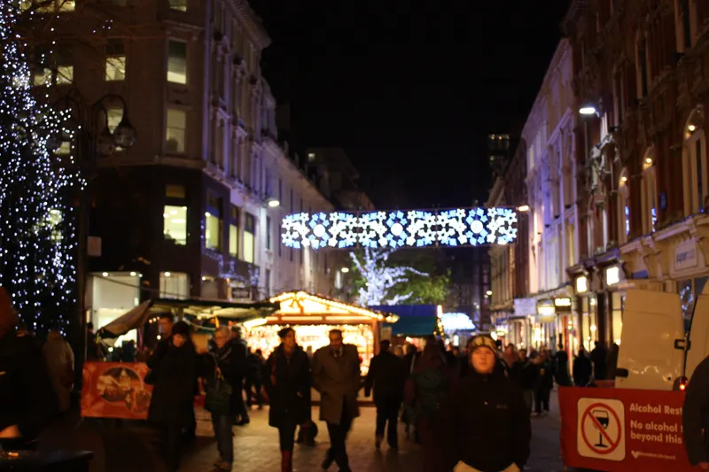 Christmas lights and market stalls on a Birmingham city centre street