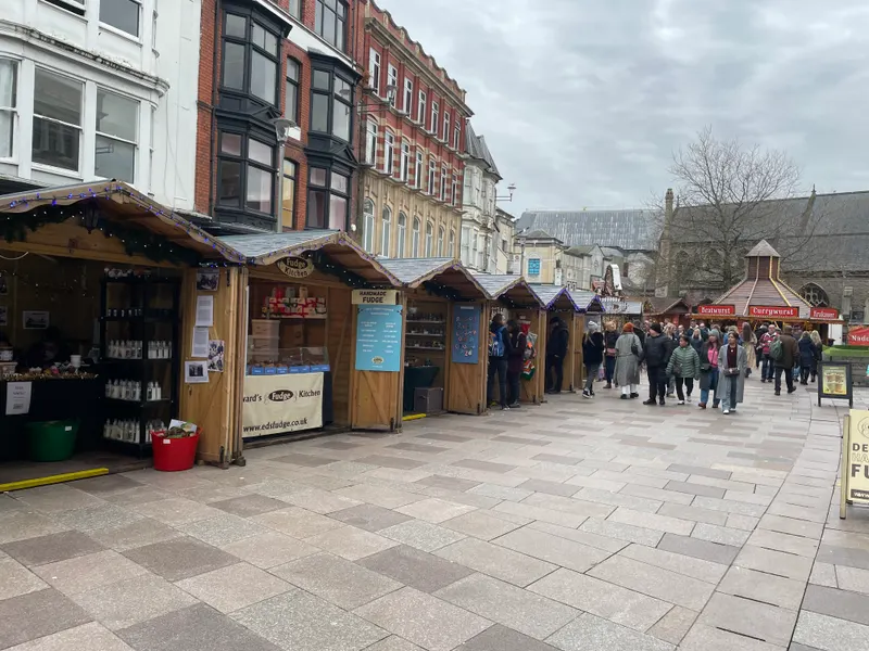 Row of wooden chalets along St John Street in Cardiff