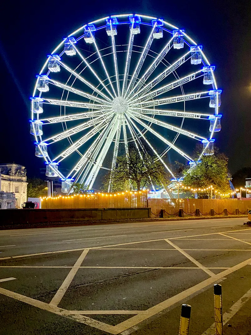 Giant wheel lit up at night at Cardiff Winter Wonderland