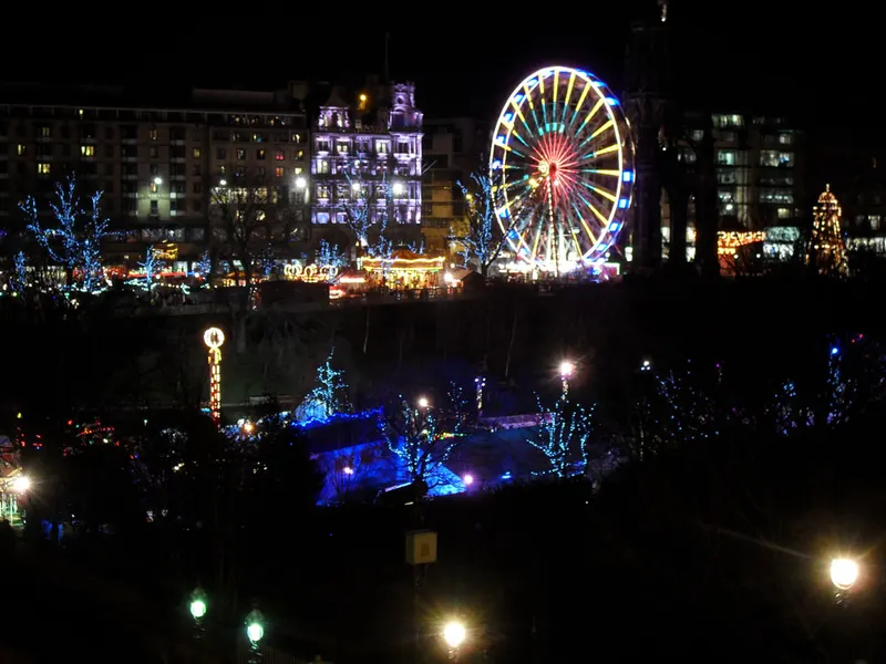 Edinburgh Christmas Market lights and big wheel in East Princes Street Gardens at night