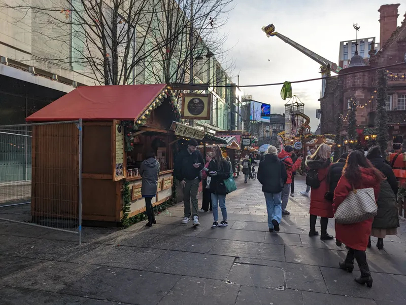 Shoppers passing the Christmas market in Glasgow city centre
