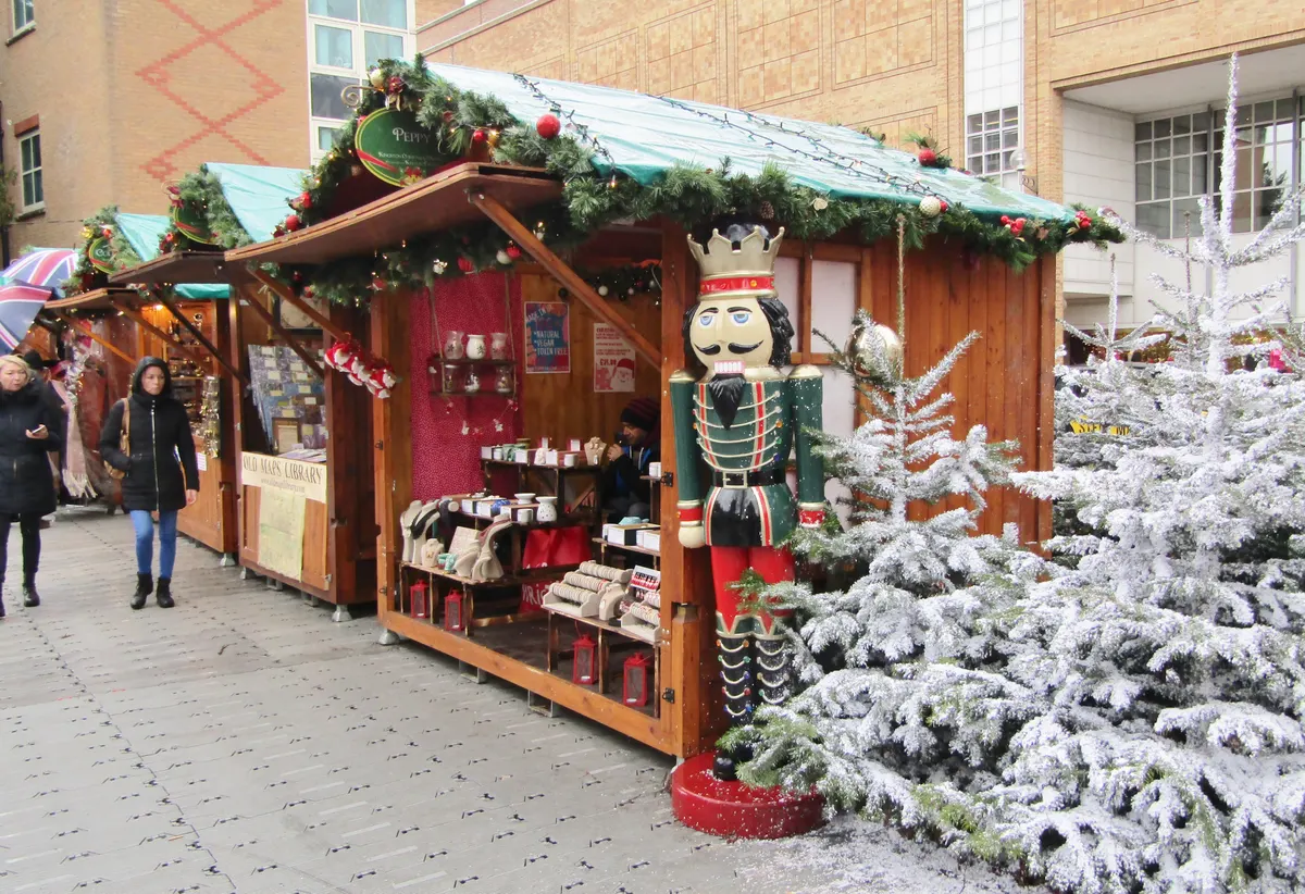 Chalet with a nutcracker figure and snowy trees at Kingston Christmas Market