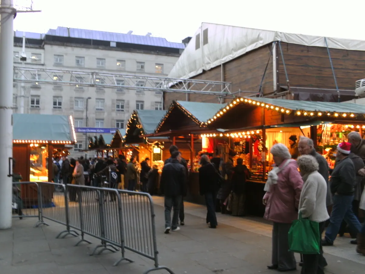 Crowds browsing wooden chalets at Leeds Christmas Market