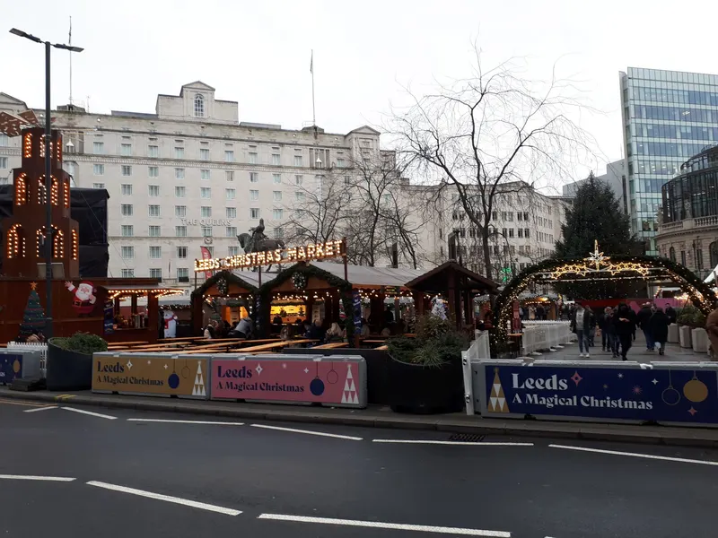 Leeds Christmas Market chalets with the A Magical Christmas banner