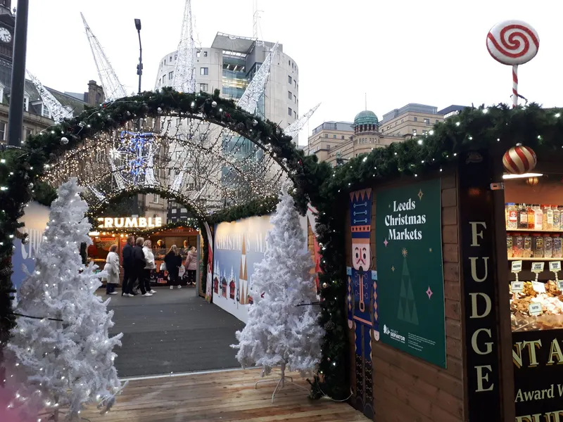 Snowy arch entrance and chalets at the Leeds Christmas Market