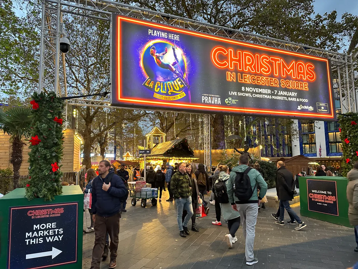 Christmas in Leicester Square sign and market entrance with festive decorations