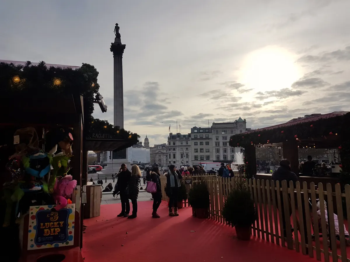 Christmas market stalls in Trafalgar Square with Nelson's Column in the background