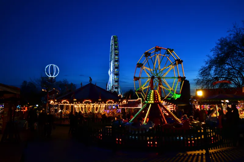 Hyde Park Winter Wonderland funfair rides lit up after dark