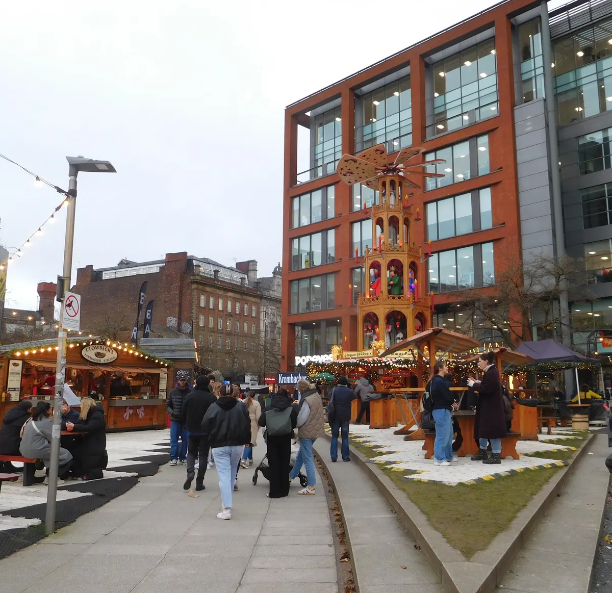 Christmas market stalls and a wooden pyramid in Manchester