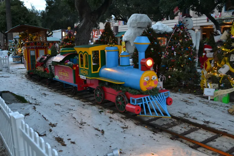 Colourful toy train on snow at Christmas in the Park in San Jose