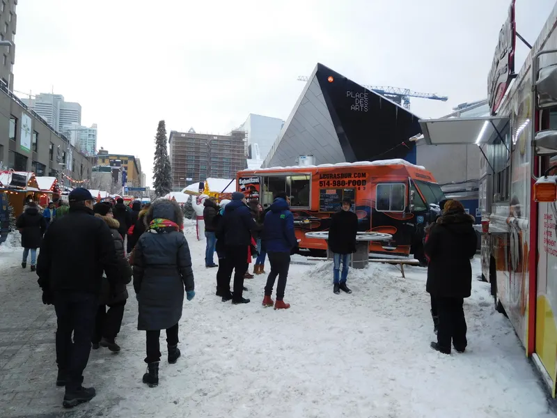 Foule sous la neige au Grand Marché de Noël de Montréal, près de la Place des Arts