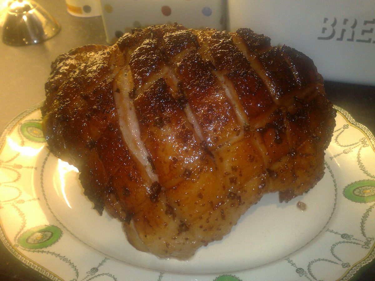 A glazed ham with a sticky brown sugar and honey glaze